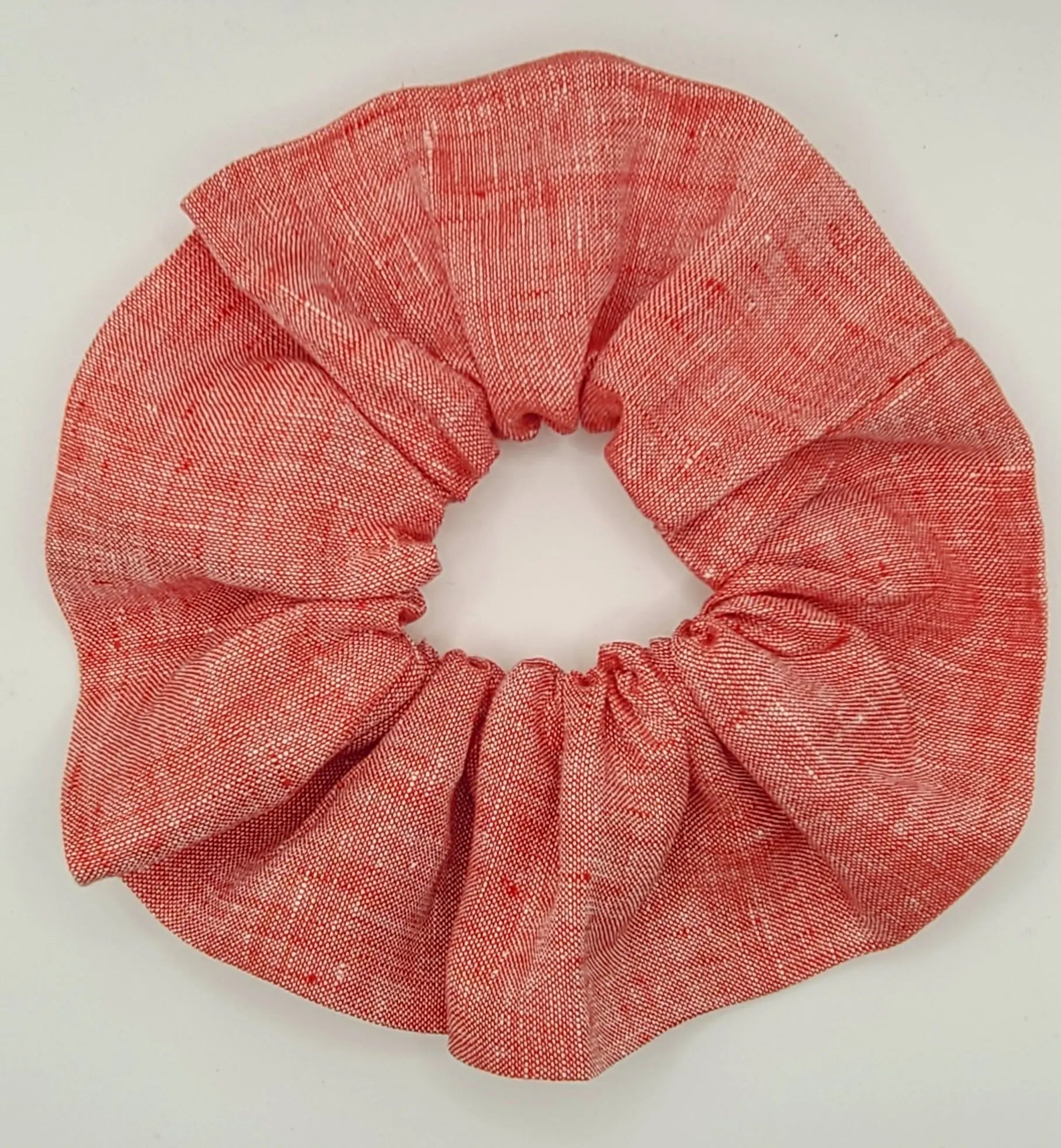 Red scrunchie on a white background