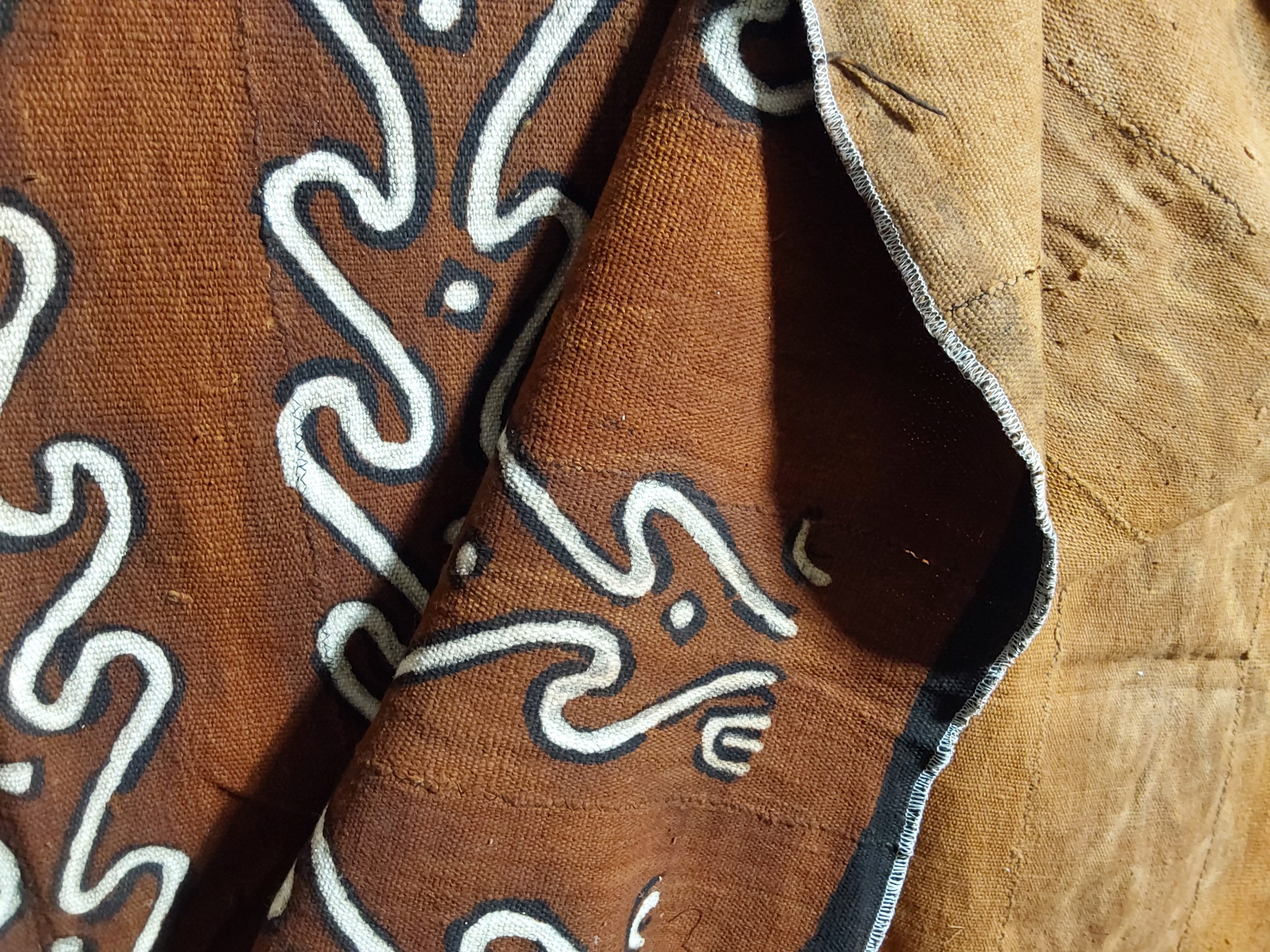 Brown fabric with white patterns on a wooden surface