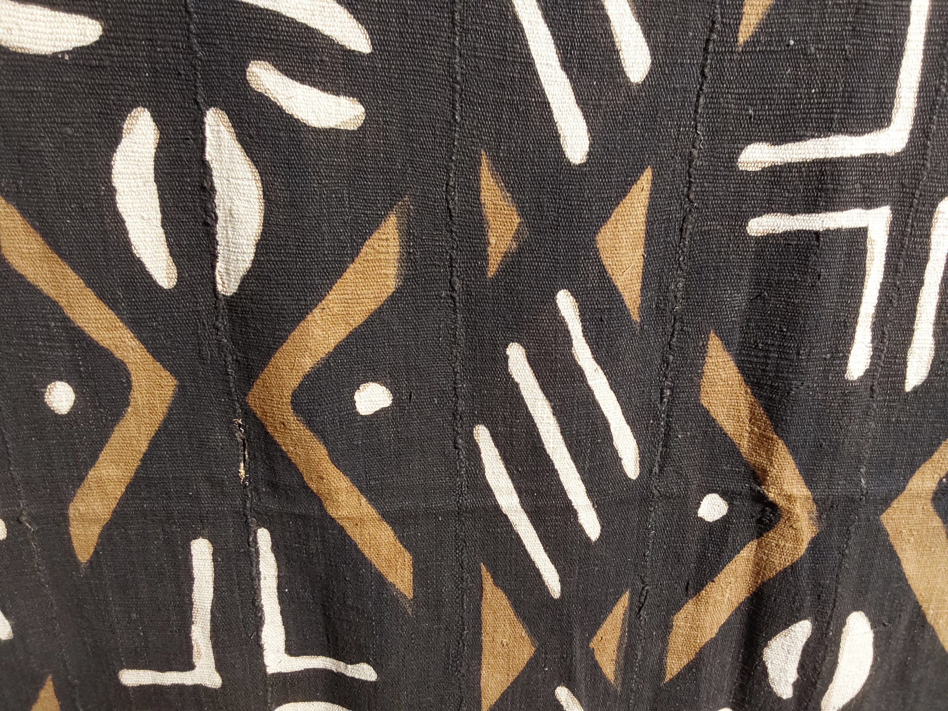 Close-up of a fabric with geometric pattern featuring black, brown, and white colors.