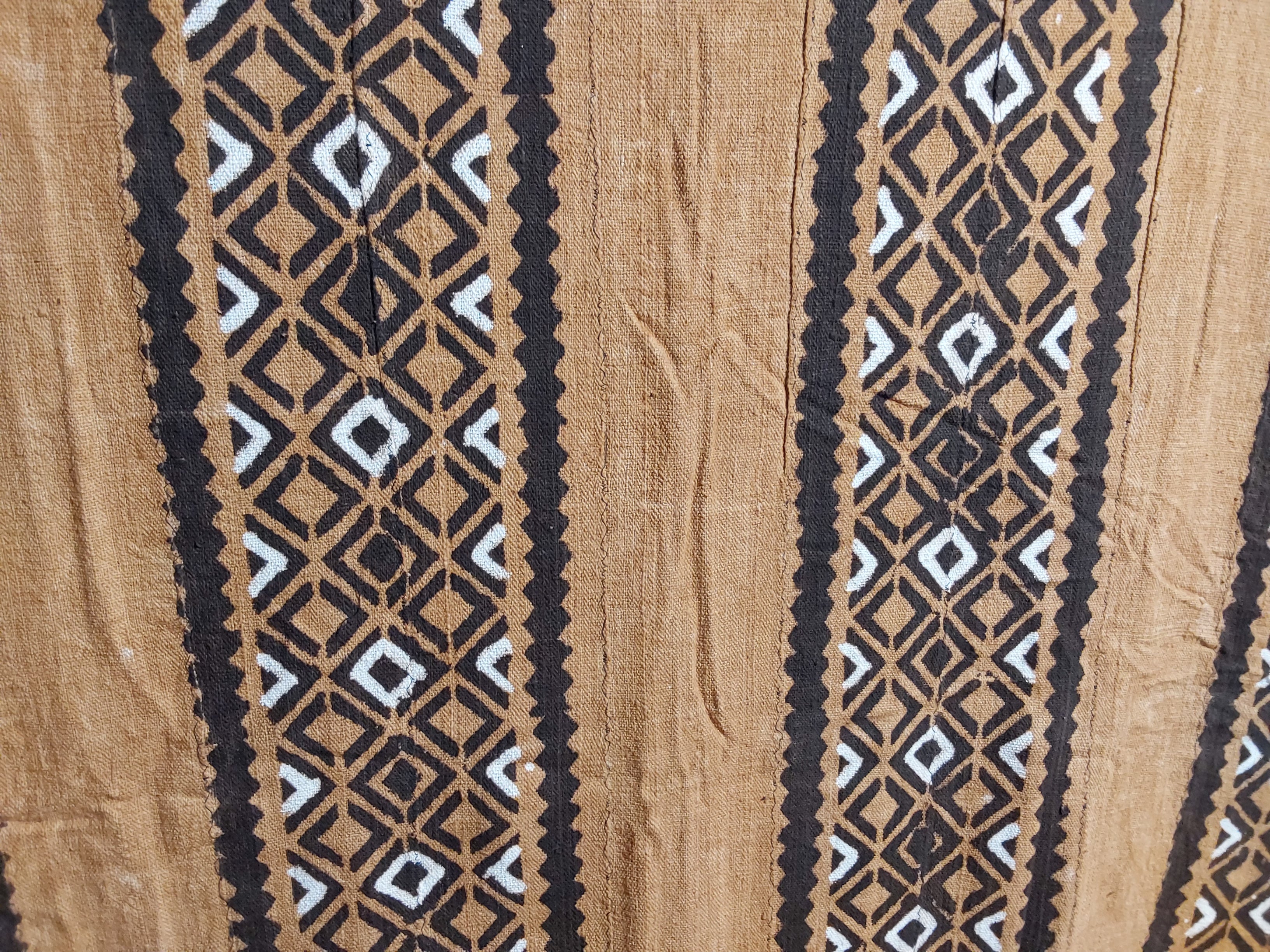 Close-up of a fabric with a geometric pattern on a beige background