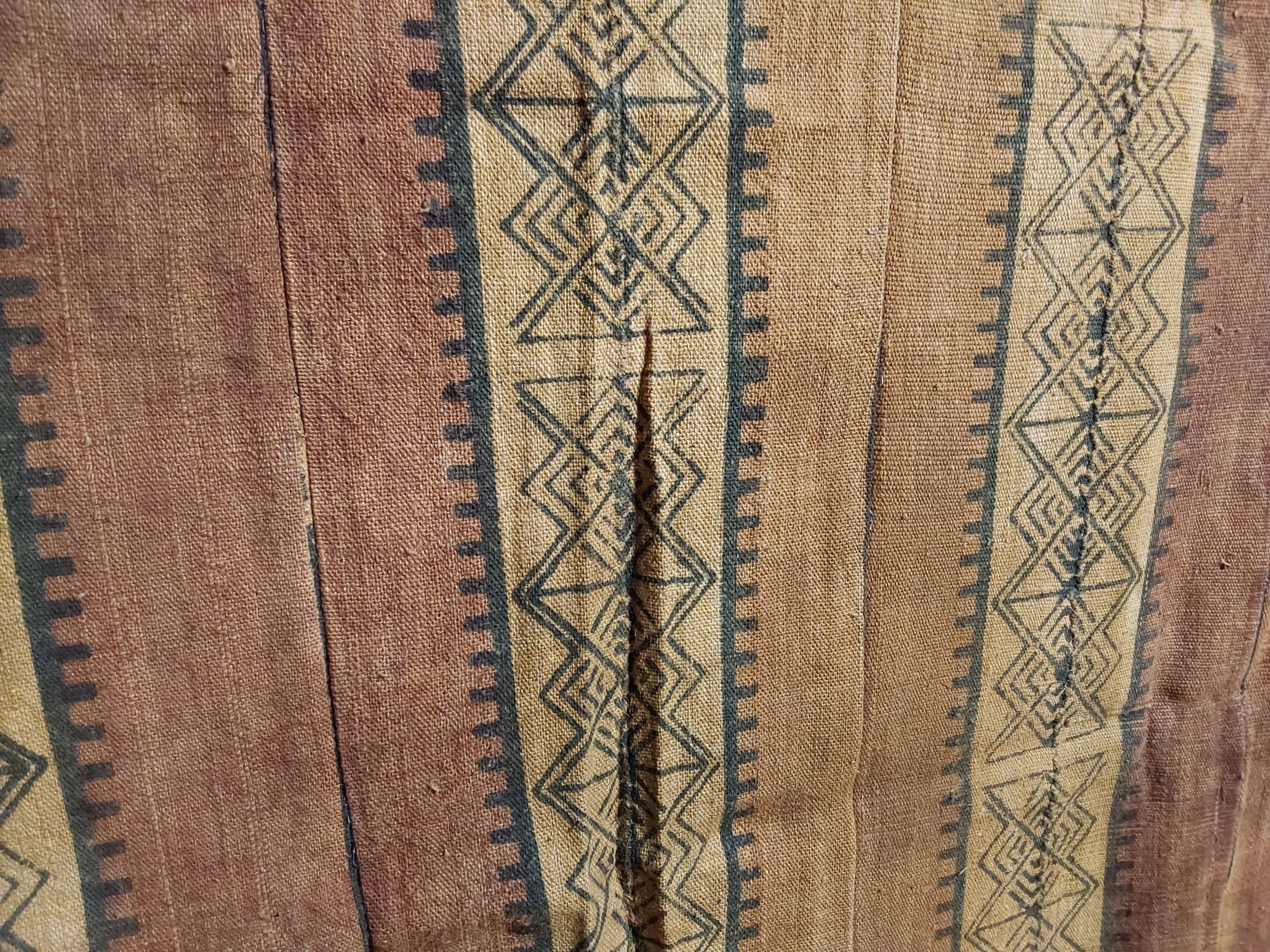 Textile with geometric patterns on a brown background