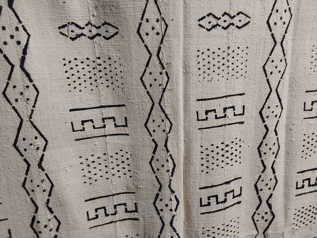 Textile with black geometric patterns on a beige background