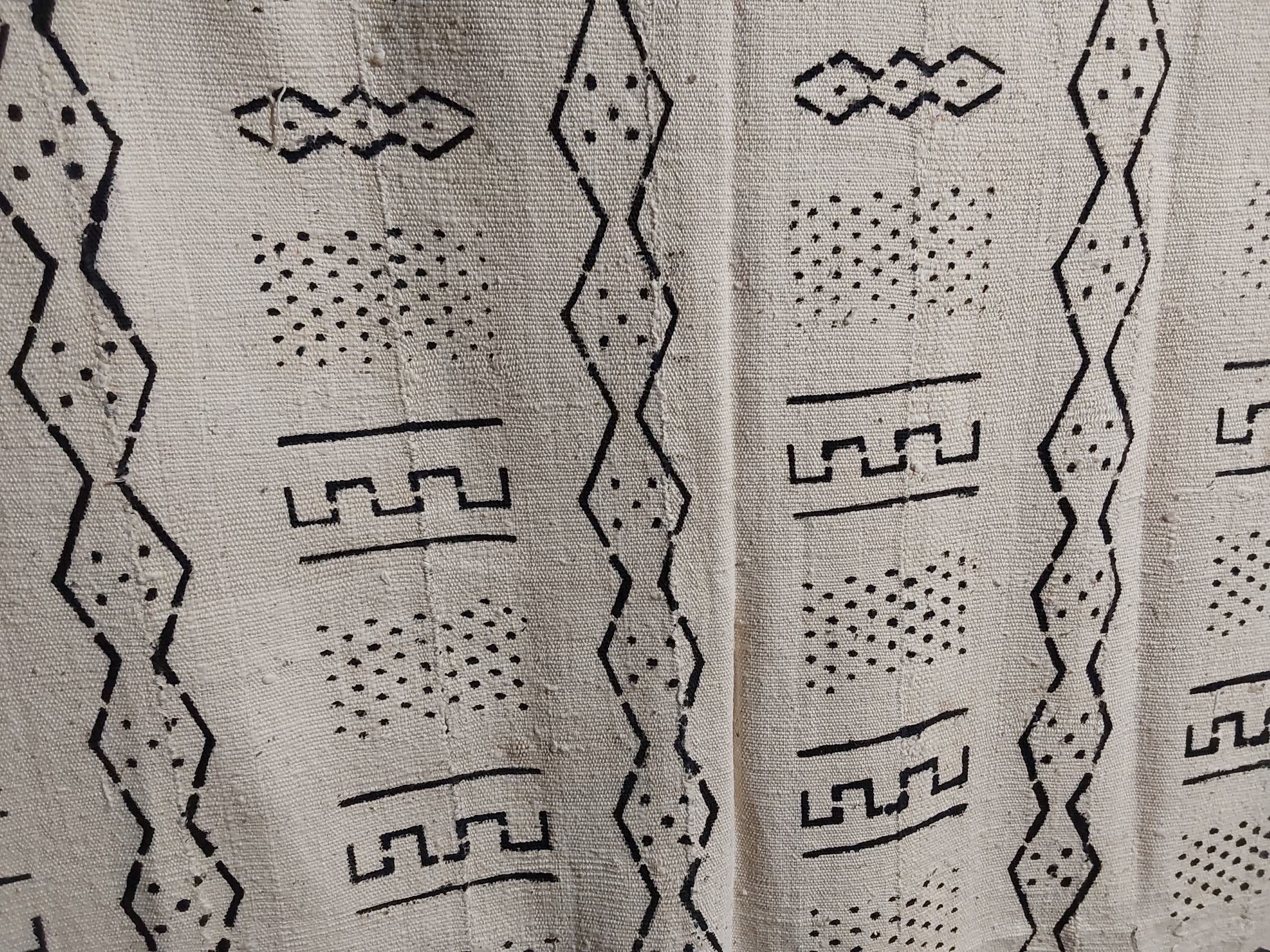 Textile with black geometric patterns on a beige background