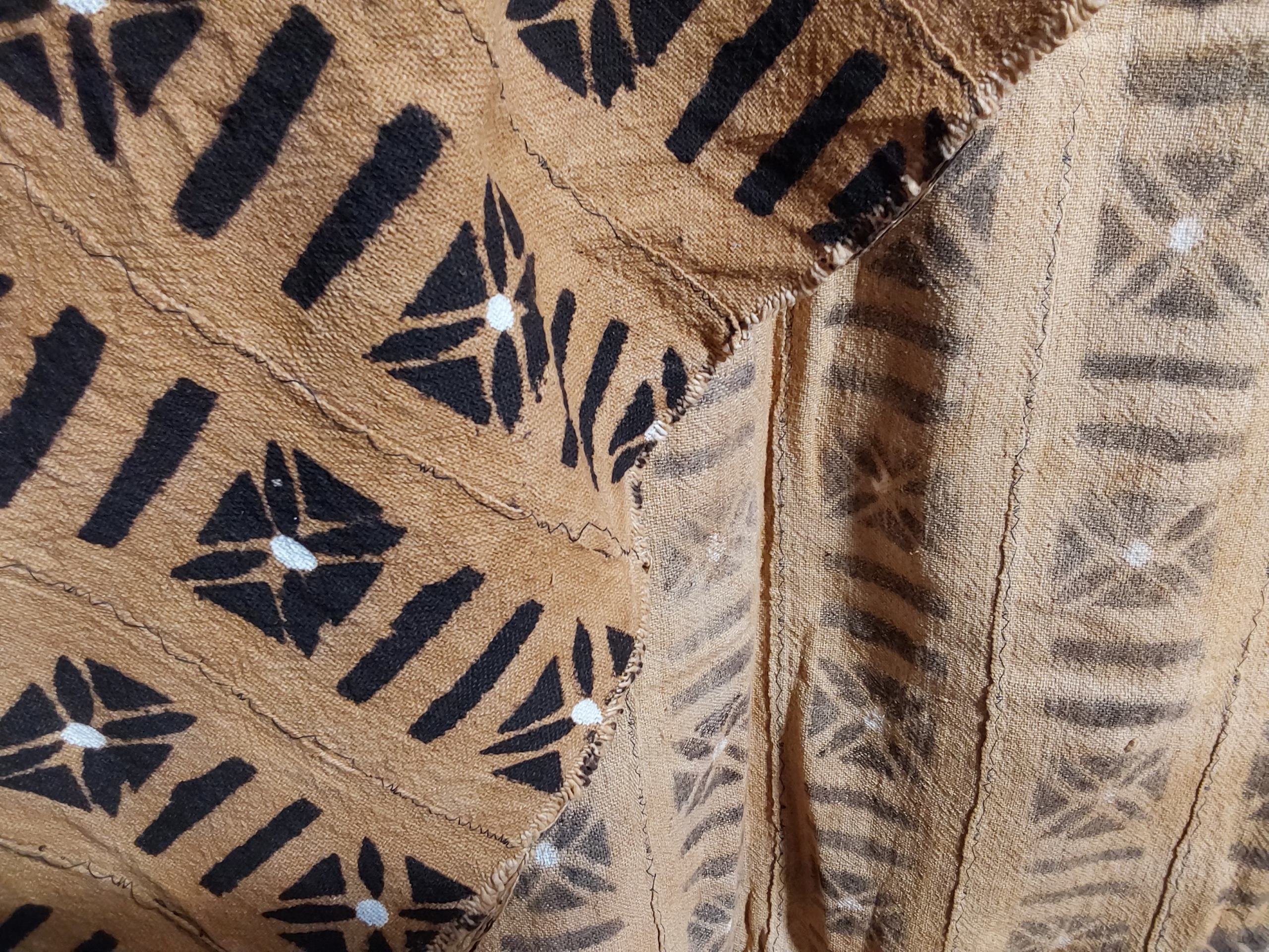 Close-up of a textured fabric with black geometric patterns on a beige background