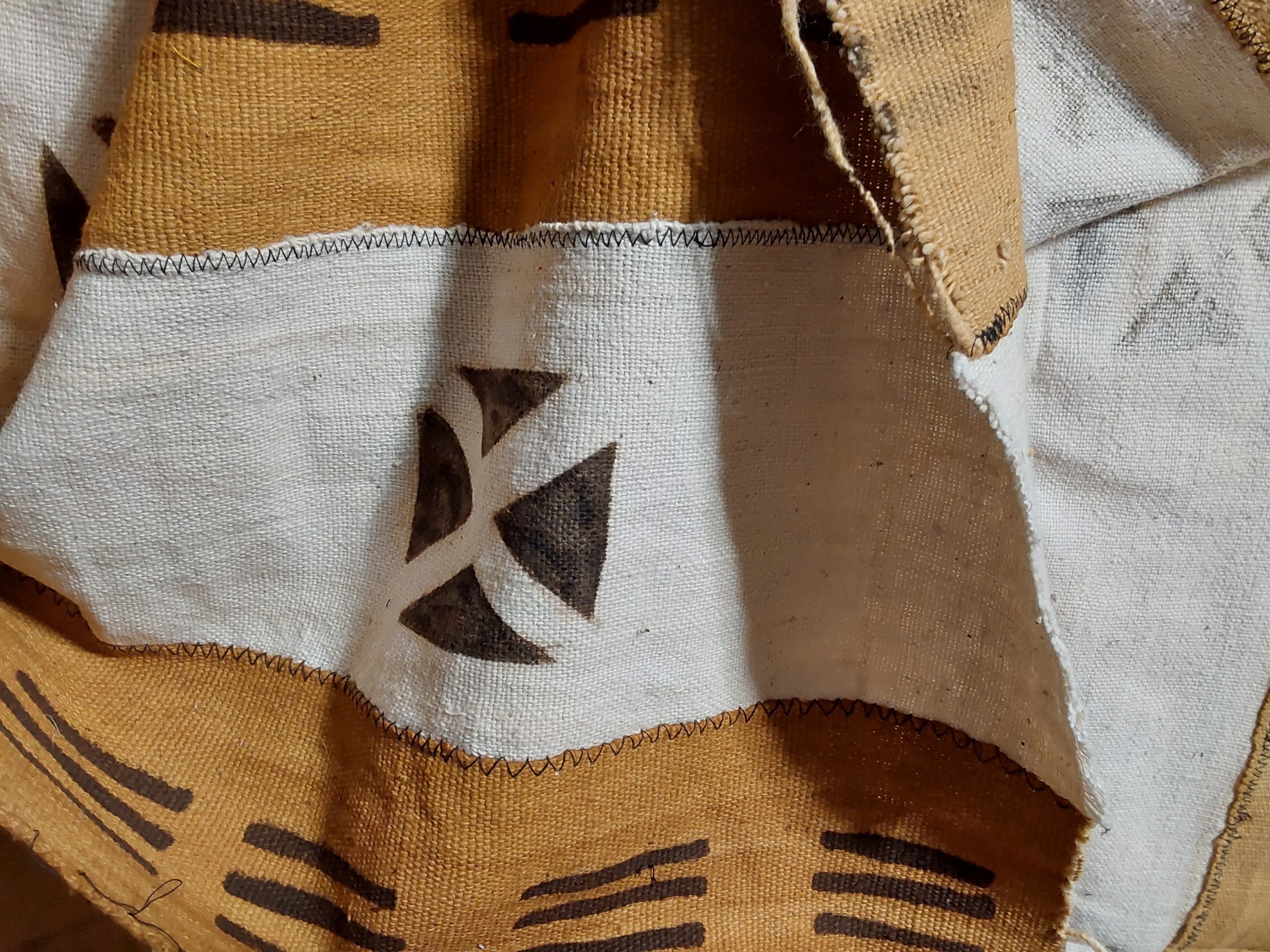 Close-up of a fabric with geometric patterns in brown and white.