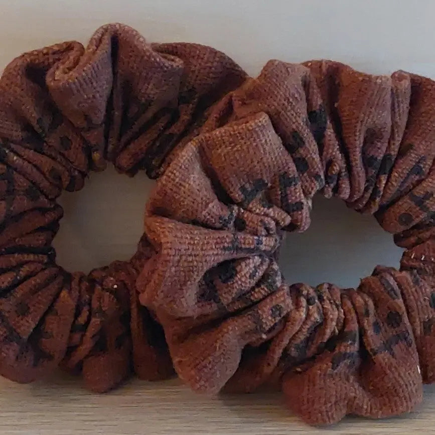 Brown scrunchie on a light wooden surface