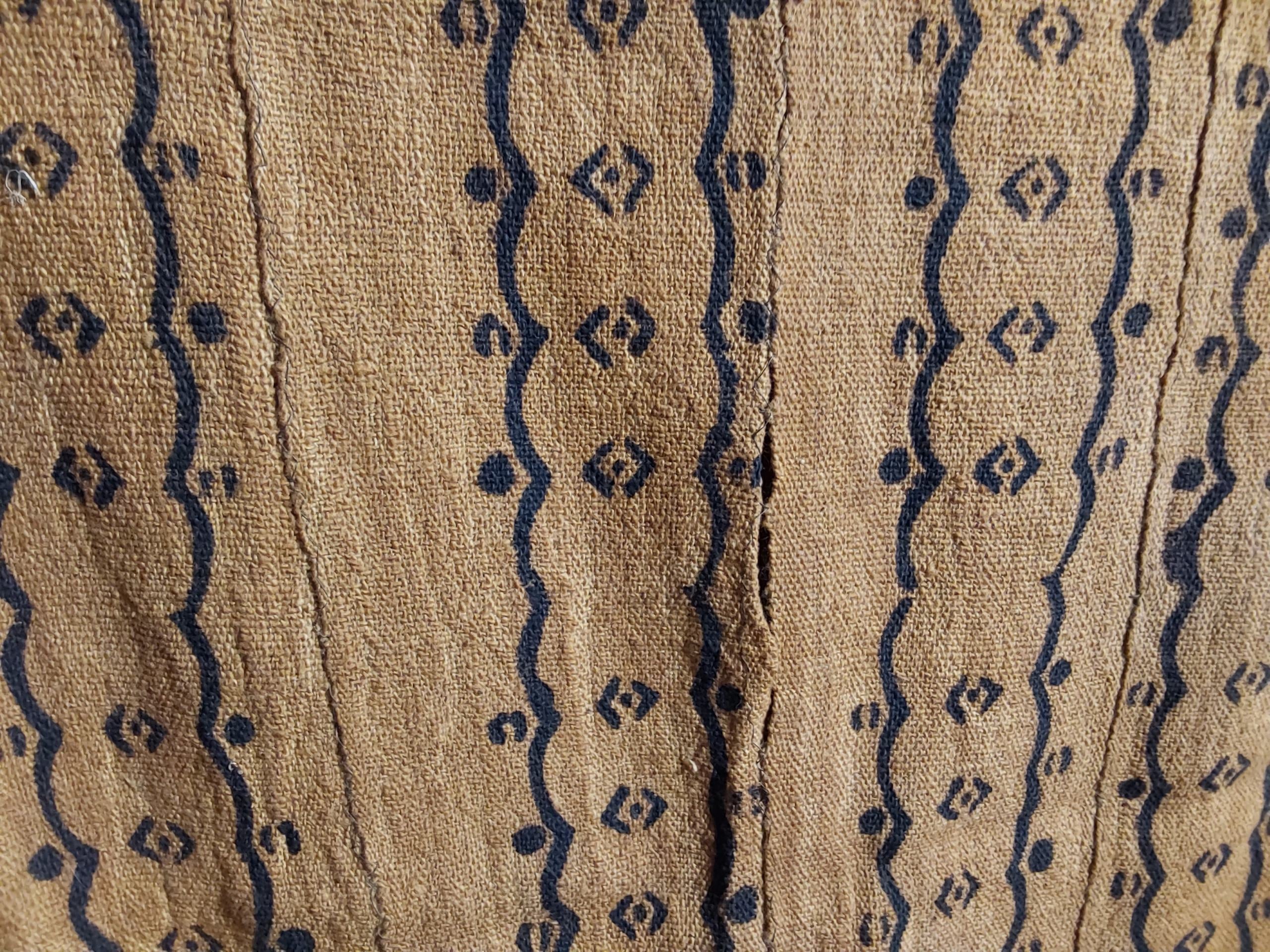 Textile with blue geometric patterns on a beige background