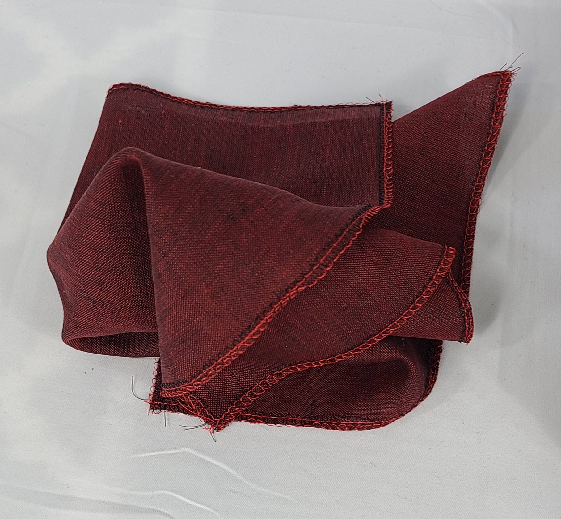 Folded burgundy fabric on a white background