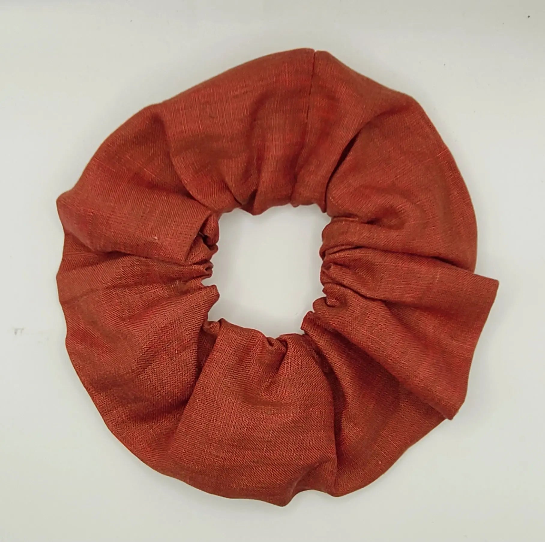 Orange brown scrunchie on a white background
