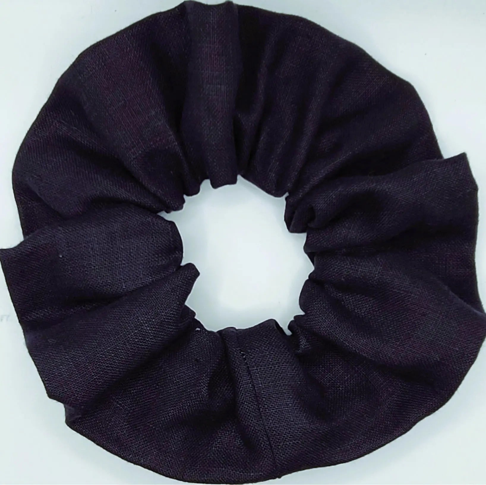 Navy blue scrunchie on a white background