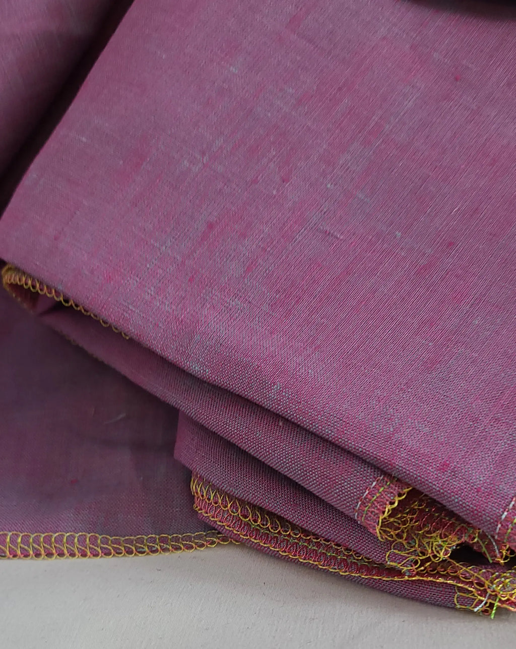 Folded Light purple linen fabric on awhite background