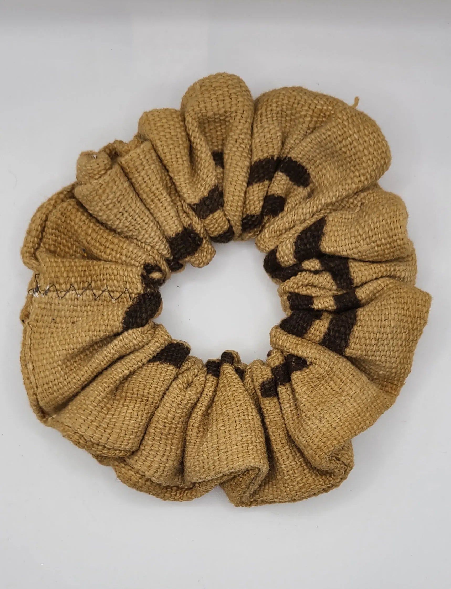 Brownshyellow mudcloth scrunchie  with black lines on a white background