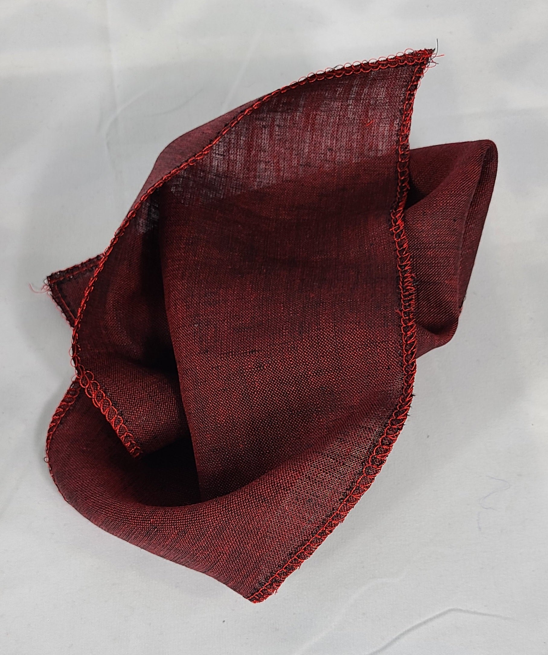 Folded wine colored pocket square on white backgound