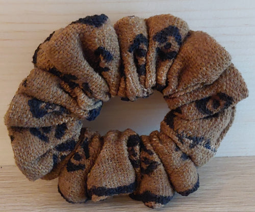 Eye design scrunchie on a wooden surface