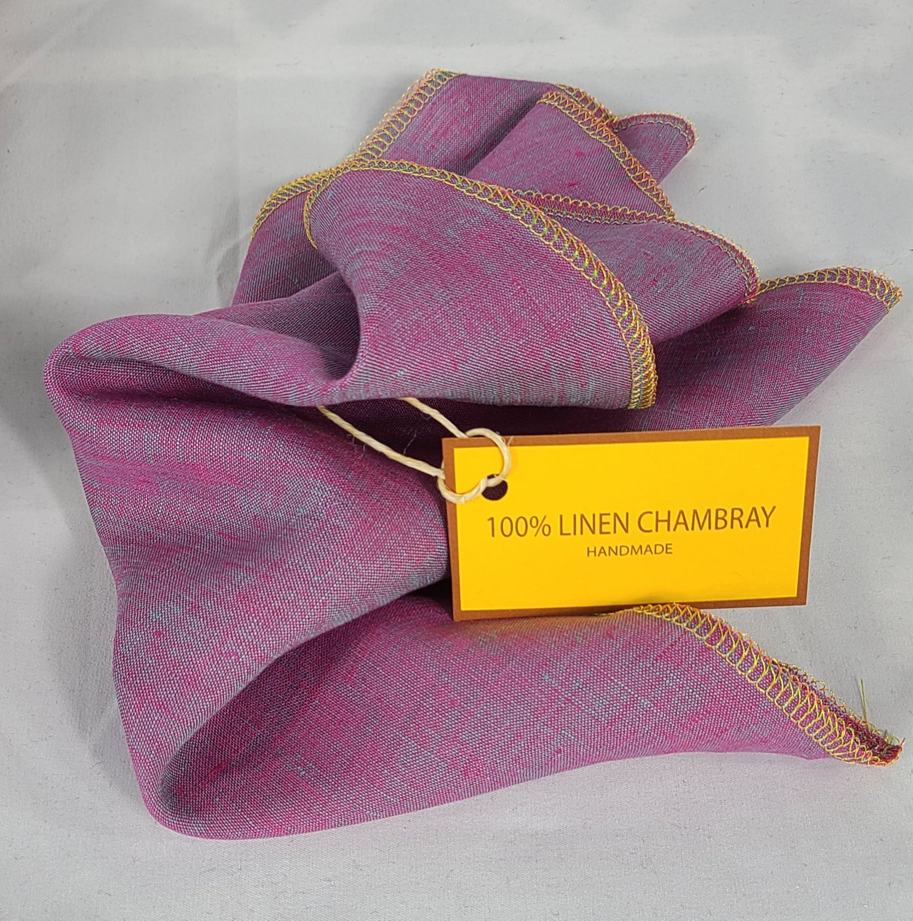 Purple fabric with gold trim and a yellow label on a white background