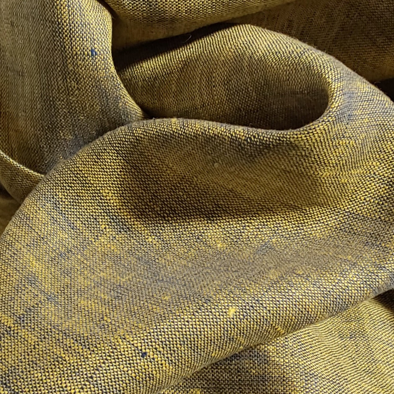 Close-up of textured brown fabric with a subtle pattern