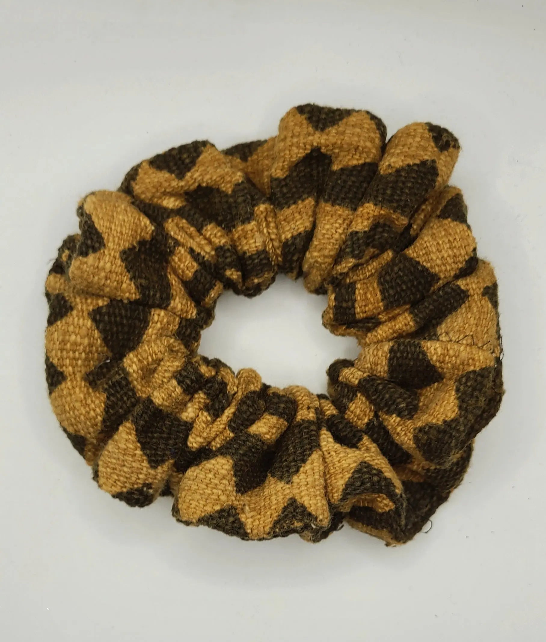 Brown and beige patterned scrunchie on a white background